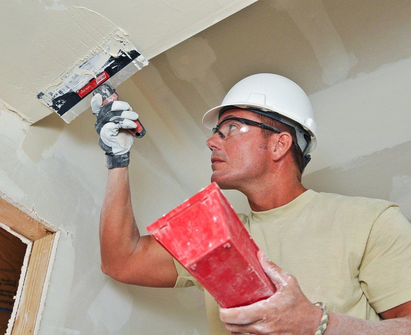 Uzy of Flex Drywall finishing a wall